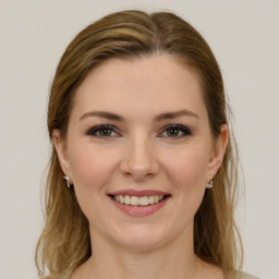 Joyful white young-adult female with long  brown hair and green eyes