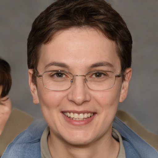 Joyful white adult female with medium  brown hair and blue eyes