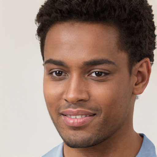 Joyful black young-adult male with short  brown hair and brown eyes