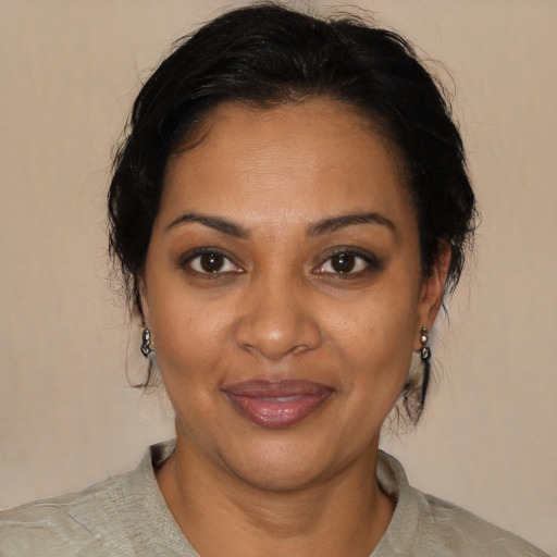 Joyful black adult female with medium  brown hair and brown eyes