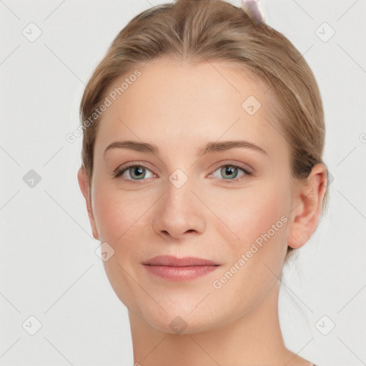 Joyful white young-adult female with short  brown hair and blue eyes