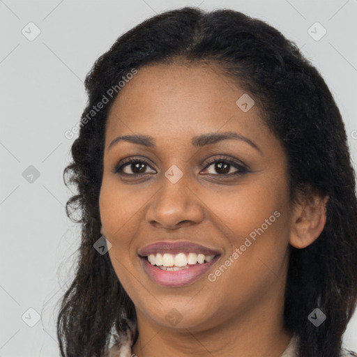 Joyful black young-adult female with long  brown hair and brown eyes