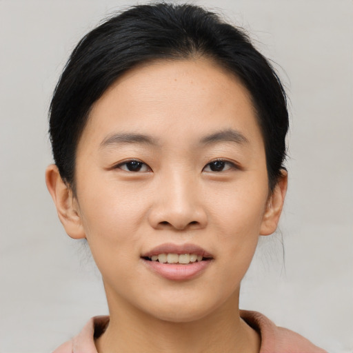 Joyful asian young-adult female with short  brown hair and brown eyes