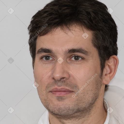 Joyful white adult male with short  brown hair and brown eyes