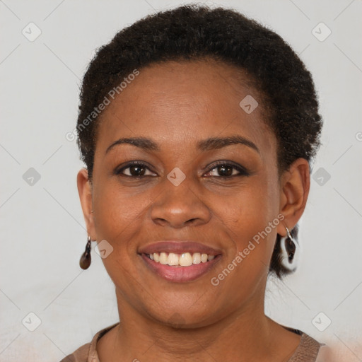 Joyful black young-adult female with short  brown hair and brown eyes