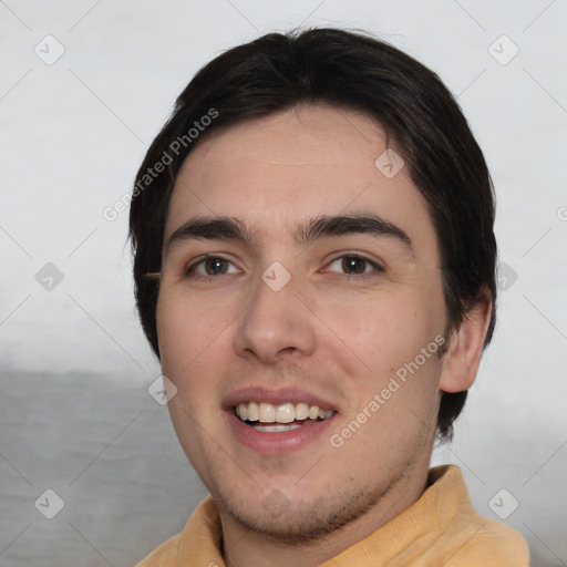 Joyful white young-adult male with short  black hair and brown eyes