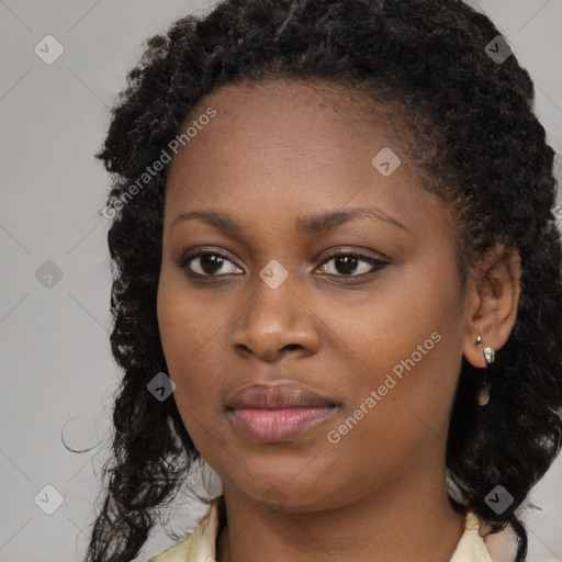 Joyful black young-adult female with long  brown hair and brown eyes