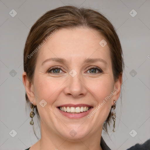 Joyful white adult female with medium  brown hair and blue eyes