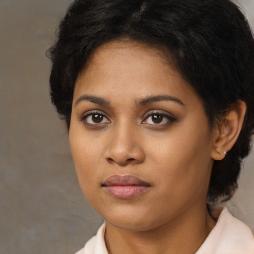 Neutral black young-adult female with medium  brown hair and brown eyes