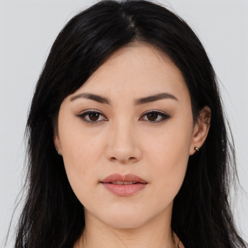 Joyful asian young-adult female with long  black hair and brown eyes