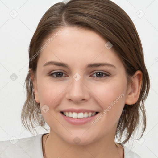 Joyful white young-adult female with medium  brown hair and grey eyes