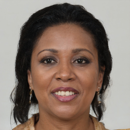Joyful black adult female with medium  brown hair and brown eyes