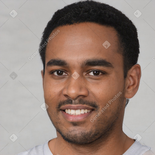 Joyful black young-adult male with short  black hair and brown eyes