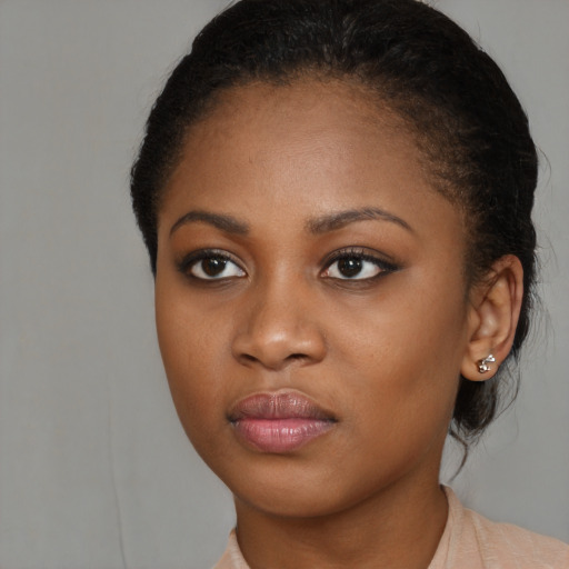 Joyful black young-adult female with medium  brown hair and brown eyes