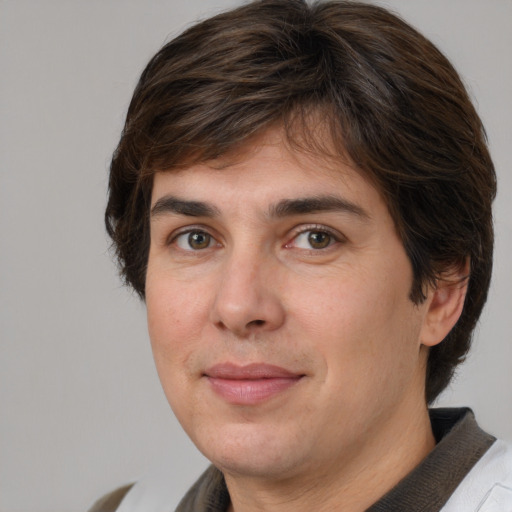 Joyful white adult male with medium  brown hair and brown eyes