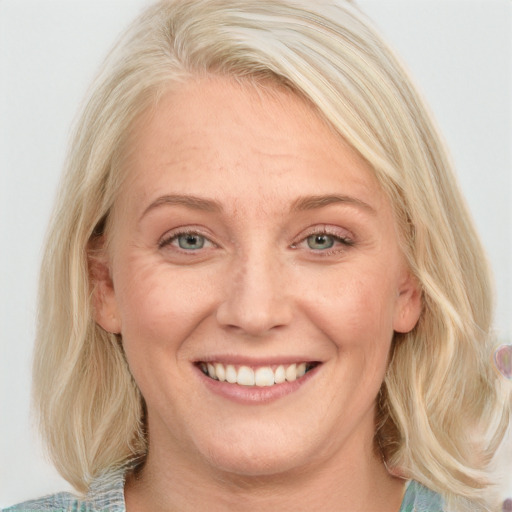 Joyful white young-adult female with medium  blond hair and blue eyes