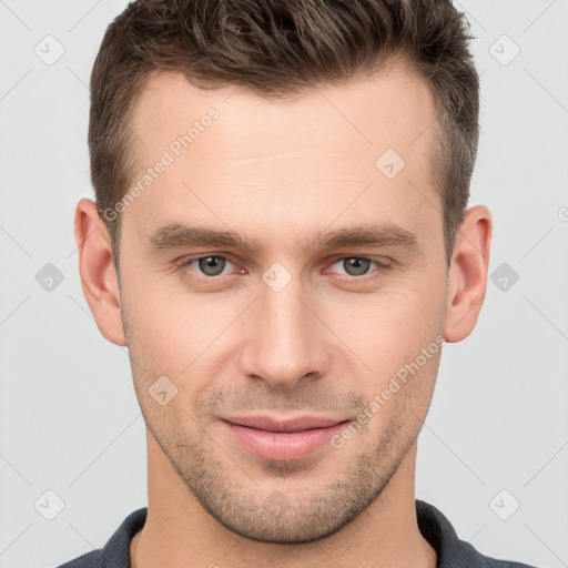 Joyful white young-adult male with short  brown hair and grey eyes