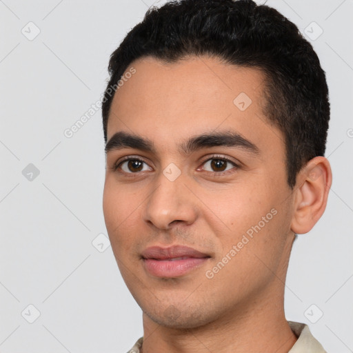 Joyful white young-adult male with short  black hair and brown eyes