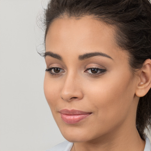 Joyful latino young-adult female with long  brown hair and brown eyes