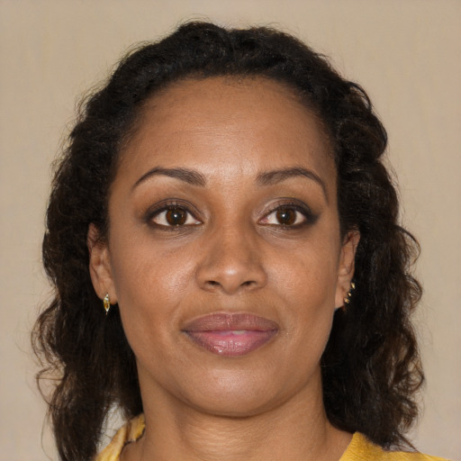 Joyful black adult female with medium  brown hair and brown eyes