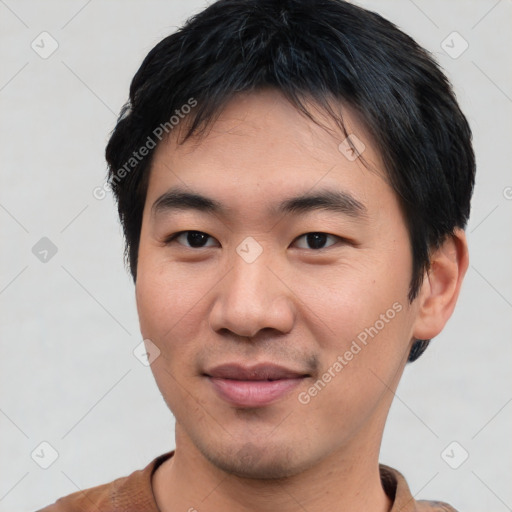 Joyful asian young-adult male with short  black hair and brown eyes