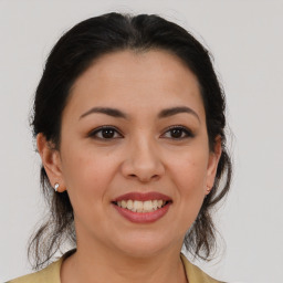 Joyful latino young-adult female with medium  brown hair and brown eyes