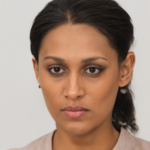 Neutral latino young-adult female with medium  brown hair and brown eyes