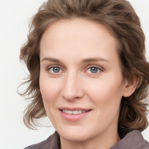 Joyful white young-adult female with medium  brown hair and blue eyes