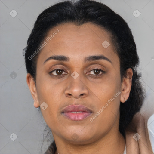 Joyful latino young-adult female with long  brown hair and brown eyes