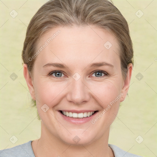 Joyful white young-adult female with short  brown hair and grey eyes