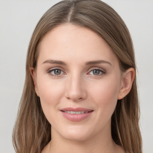 Joyful white young-adult female with long  brown hair and grey eyes