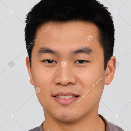 Joyful asian young-adult male with short  black hair and brown eyes