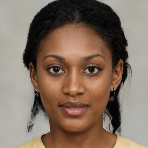 Joyful black young-adult female with medium  black hair and brown eyes