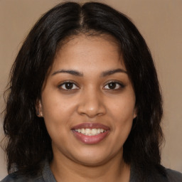 Joyful latino young-adult female with long  brown hair and brown eyes