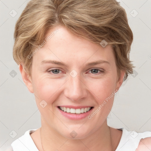 Joyful white young-adult female with short  brown hair and blue eyes