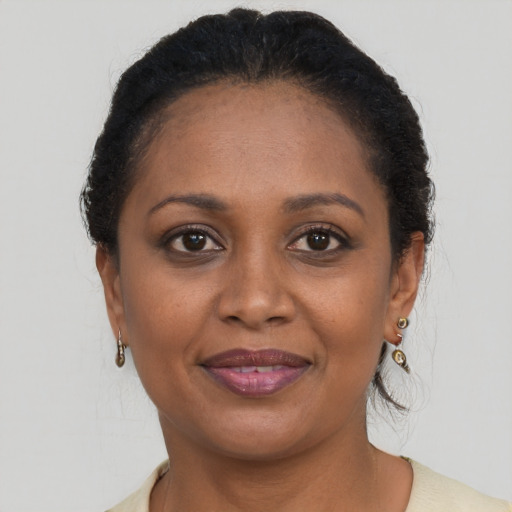 Joyful black adult female with short  brown hair and brown eyes