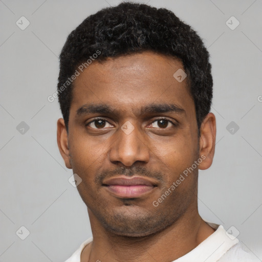 Joyful black young-adult male with short  black hair and brown eyes