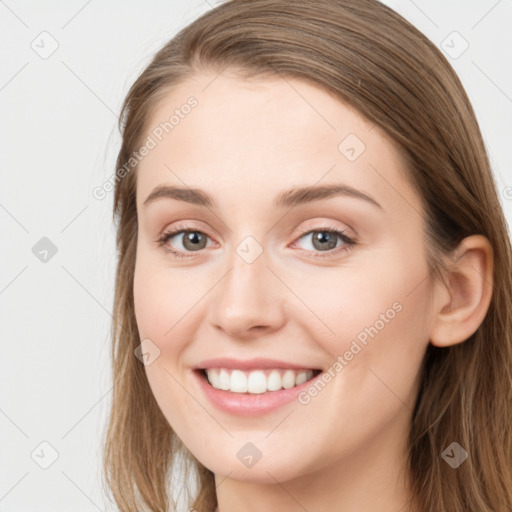 Joyful white young-adult female with long  brown hair and blue eyes