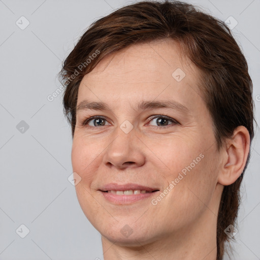 Joyful white adult female with medium  brown hair and brown eyes