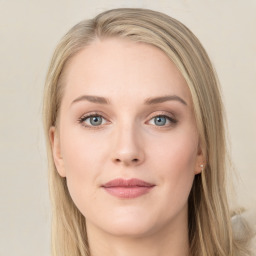 Joyful white young-adult female with long  brown hair and green eyes