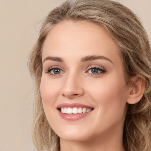 Joyful white young-adult female with long  brown hair and green eyes