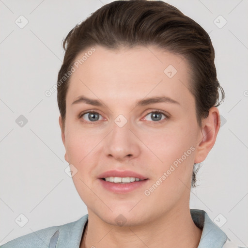 Joyful white young-adult female with short  brown hair and grey eyes