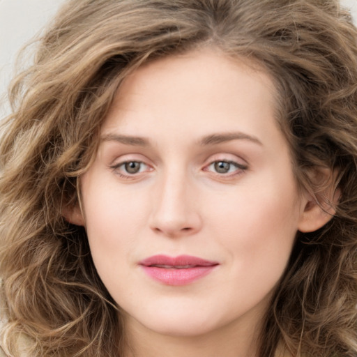 Joyful white young-adult female with long  brown hair and green eyes