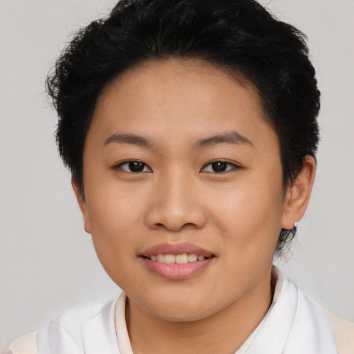 Joyful asian young-adult female with short  brown hair and brown eyes