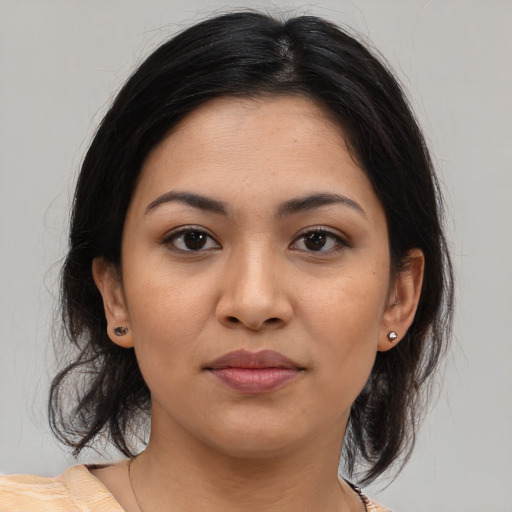 Joyful latino young-adult female with medium  brown hair and brown eyes