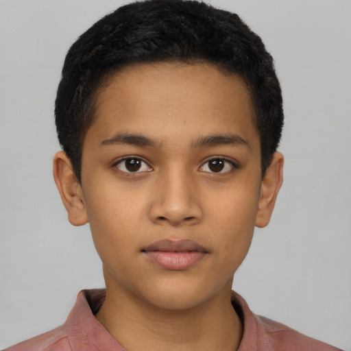 Joyful latino child male with short  brown hair and brown eyes