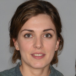 Joyful white young-adult female with medium  brown hair and blue eyes