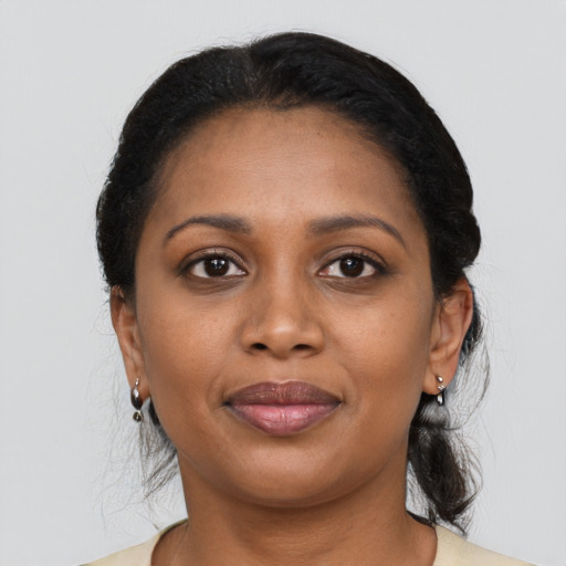 Joyful black young-adult female with medium  black hair and brown eyes