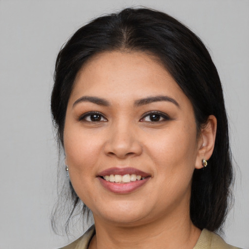 Joyful asian young-adult female with medium  black hair and brown eyes