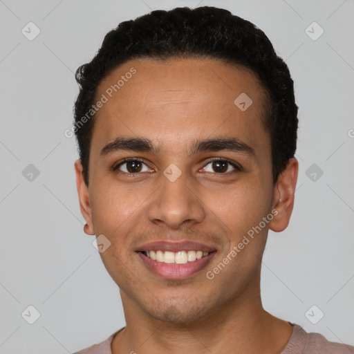 Joyful latino young-adult male with short  black hair and brown eyes